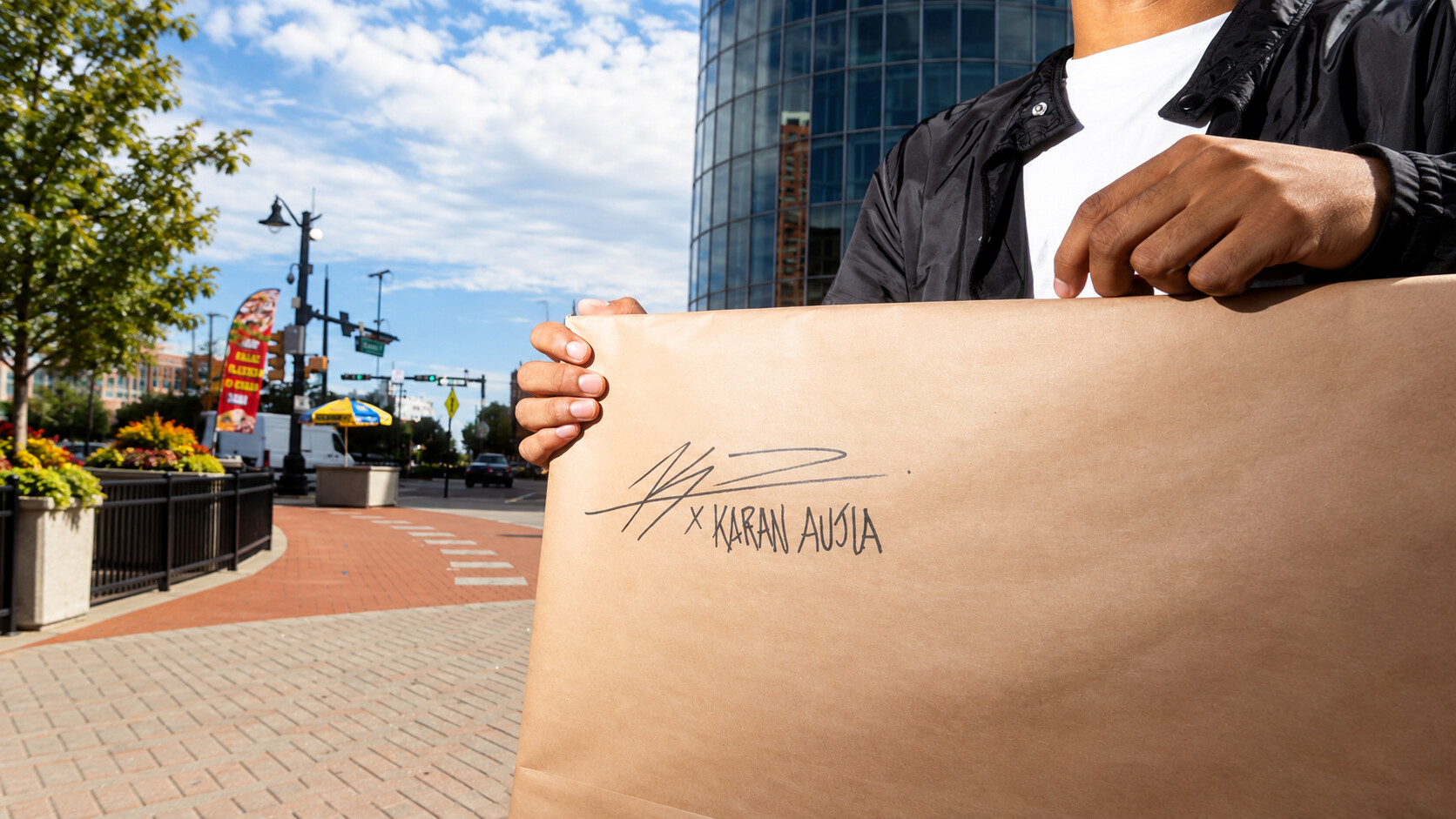 A wrapped painting signed by Kyan Patel and marked for Karan Aujla