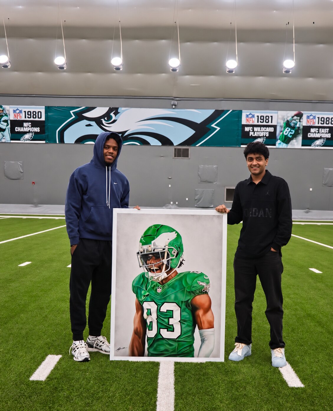 Kyan Patel and Jahan Dotson holding Kyan’s framed portrait of Dotson.