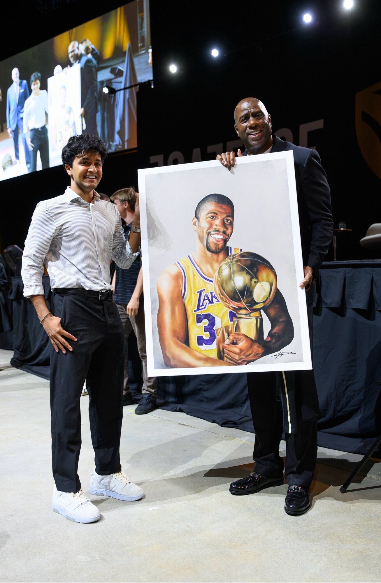 Kyan Patel and Magic Johnson holding Kyan’s portrait of him